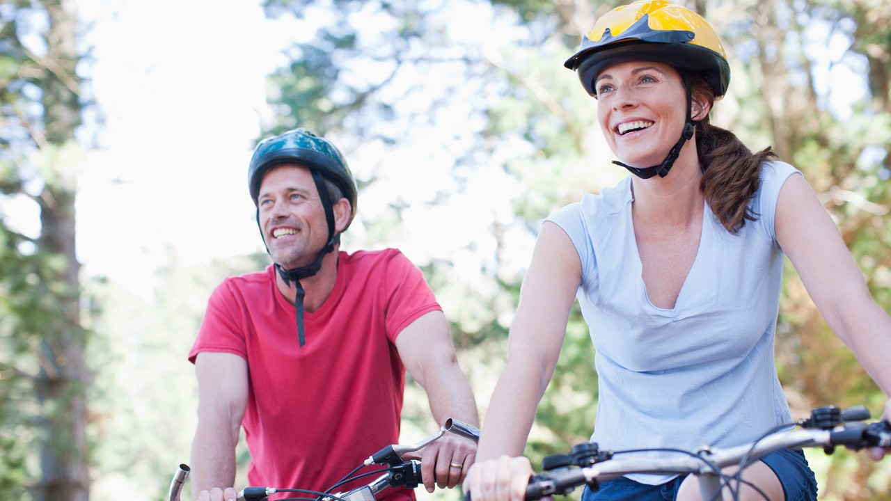 Couple bicycle riding in the forest